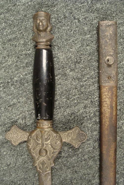 VINTAGE C1900 KNIGHTS OF COLUMBUS FRATERNAL SWORD: VINTAGE C1900 KNIGHTS OF COLUMBUS FRATERNAL SWORD-FANCY-DOUBLE ENGRAVED. * C1900 KNIGHTS OF COLUMBUS FRATERNAL SWORD AND SCABBARD. THE POMMEL IS A LIKENESS OF CHRISTOPHER COLUMBUS. THE GRIP IS BLACK P