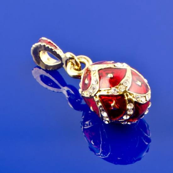 Red Enameled Faberge Pendant: Red Enameled Faberge Pendant. The egg is made by using a red guilloche enamel technique with small diamonds attached all over. The red enamel and golden color combination makes the contrasting bright 