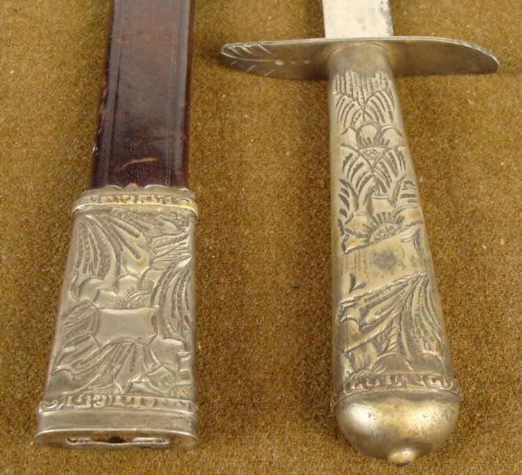 CUSTOM MADE ARGENTINIAN GAUCHO SHORT SWORD LA MOVEDIZA: THIS IS AN OUTSTANDING CUSTOM MADE GAUCHO SHORT SWORD BY THE RENOWN BLADE MAKER OF ARGENTINA, LA MOVEDIZA. THE SWORD HAS AN INTRICATE FLORAL AND FILEGREE DESIGNS IN SILVER GRIP AND SCABBARD FITT