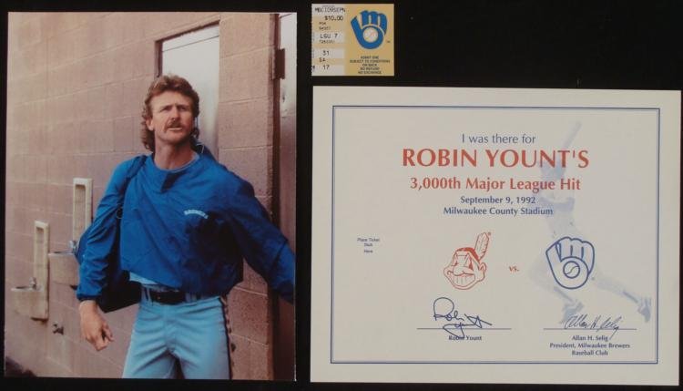 Robin Yount 3000th Career Hit- Photograph and Ticket: Come and celebrate Major League Baseball history with this 8x10 photograph of Hall of Famer Robin Yount. He is leaving the locker room with warm-up coat on and a small duffle bag on his shoulder. Robi