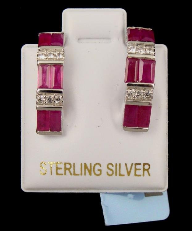 Sterling Silver .15 CT Sapphire & 2.3 CT Ruby Earrings: Offered here is a .15 carats, 12 piece white sapphire earrings. The earrings are made out sterling silver, weighs 3.00 grams and contains 12 pieces of 2.30 carats of ruby. 