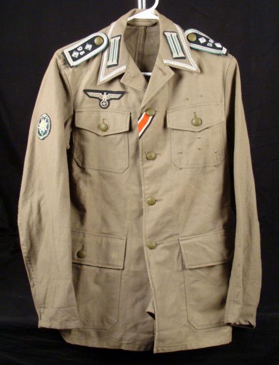 West German Tunic w/ Repro Nazi Insignia, Swastika: This is a West German Tunic with reproduction Nazi Insignia. These include eagle and swastika and edelweiss patches, shoulder bars with pips, and collar tabs. The size is not marked, but the jacket me