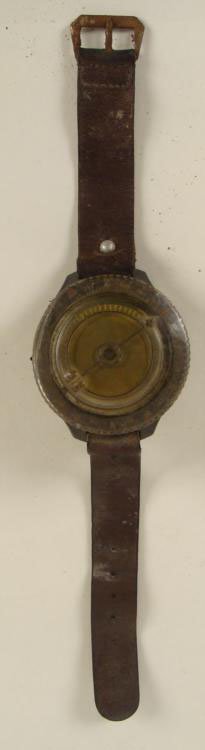Russian Paratrooper Military Compass Watch: Here is a Russian Paratrooper Compass Watch. It features a rotating bezel with arrow above a black ring of white numbers. The plastic has yellowed a bit. The back has a red line, and the letters sbe. 