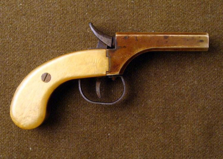 CLASSIC ARMS SNAKE EYES DERRINGER: This is a "snake eye derringer" or "sash gun." It is from a kit from the 1970's. The pistol is a double-barrel, double-hammer, single, with percussion cap or ball and cap mechanism. The muzzle is 11/3