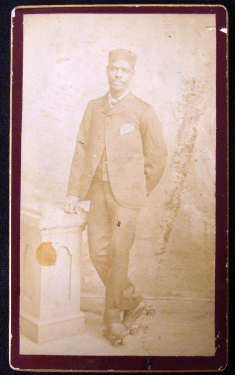 Rare Antique CDV Photo African American w/Rollerskates: This antique carte de visite photo is a portrait of a African American bellhop wearing rollerskates. It is a studio shot, mounted on a card, with no studio name listed. The condition is good overall, 