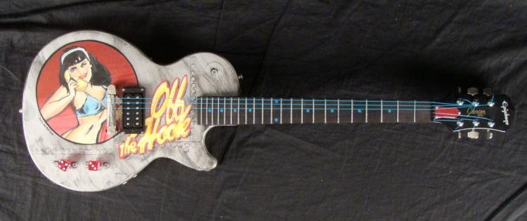 Duerrstein Original Painted Guitar USAF Pin-Up Girl: Just like a U.S. Air Force fighter plane, this guitar has been painted with a sexy pin-up girl. This one and only custom piece is a real guitar all done up by artist Dick Duerrstein, who has a knack f