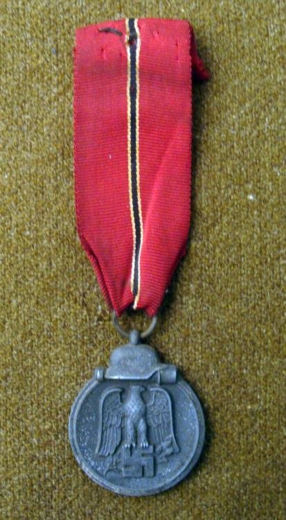 NAZI MEDAL WINTER CAMPAIGN IN RUSSIA 1941/1942 ORIGINAL: HERE IS AN ORIGINAL NAZI MEDAL FOR WINTER CAMPAIGN IN RUSSIA, 1941/1942. ONT THE FRONT THERE IS A HELMET & POTATO MASHER AND EAGLE ATOP OF A SWASTIKA. THE MEDAL COMES WITH A RIBBON.&nb