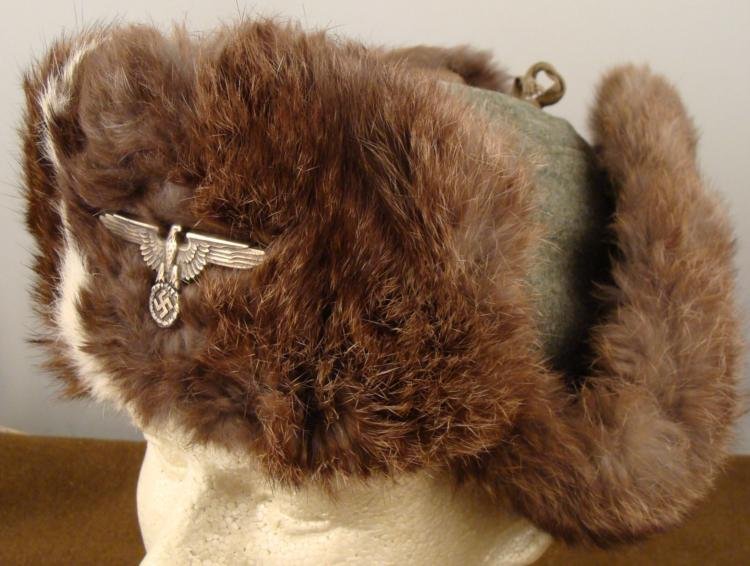 ORIGINAL SS WINTER RABBIT FUR AND GRAY WOOL HAT: OFFERED HERE IS A NICE ORIGINAL SS WINTER RABBIT FUR AND GRAY WOOL HAT. THIS WELL MADE, EARLY WAR, SS WINTER FUR FIELD HAT IS MADE OUT OF WHITE AND BROWN RABBIT FUR. THERE IS A METAL SS EA