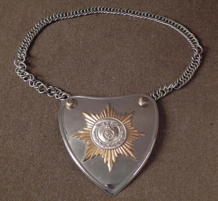 NAZI PARADE STANDARTE BEARERS GORGET W/SWASTIKA: THIS IS A NAZI PARADE STANDARTE BEARERS GORGET. IT IS HEART SHAPED WITH A SILVER GORGET. THE GORGET HAS A SILVER LINK CHAIN & A GOLD STAR BURST WITH EAGLE, WREATH AND SWASTIKA AT THE C