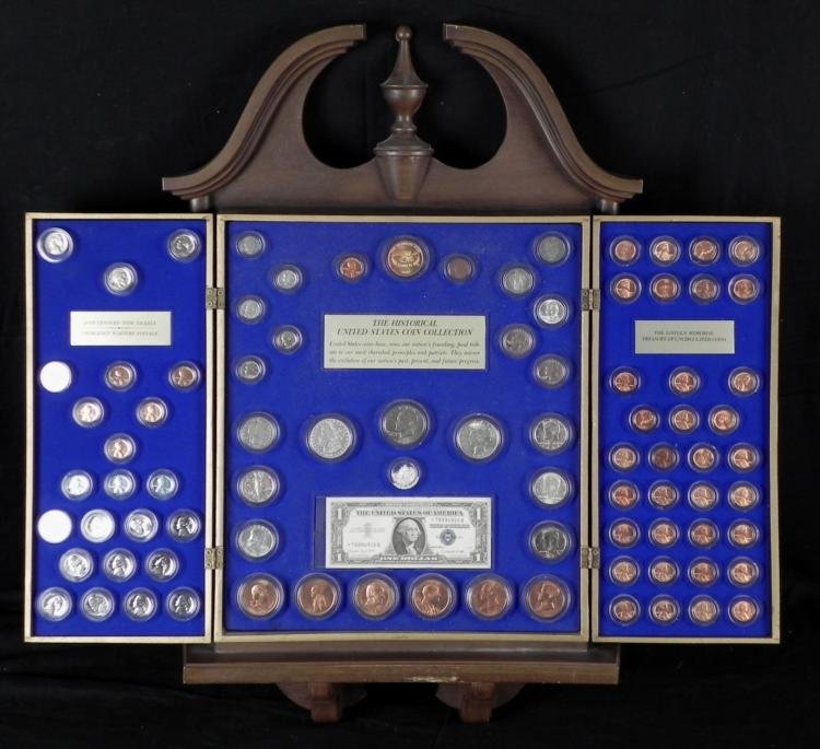 Kennedy Mint Historical U.S. Coin Collection in Case: This is the Kennedy Mint Historical U.S. Coin Collection. It is in complete condition, and comes in a handsome wood case. The case is all wood, with hinged doors, and gold colored eagle coin on front.