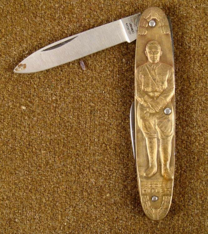 HITLER NAZI TWO BLADE POCKET KNIFE: HERE IS A HITLER/NAZI TWO BLADE POCKET KNIFE. THE KNIFE SHOWS HITLER & DEUTSCHLAND ERWACHT WITH EAGLE AND SWASTIKA. IT IS 3 1/2" LONG AND THE BLADE IS MARKED "SOLINGEN GERMANY". 