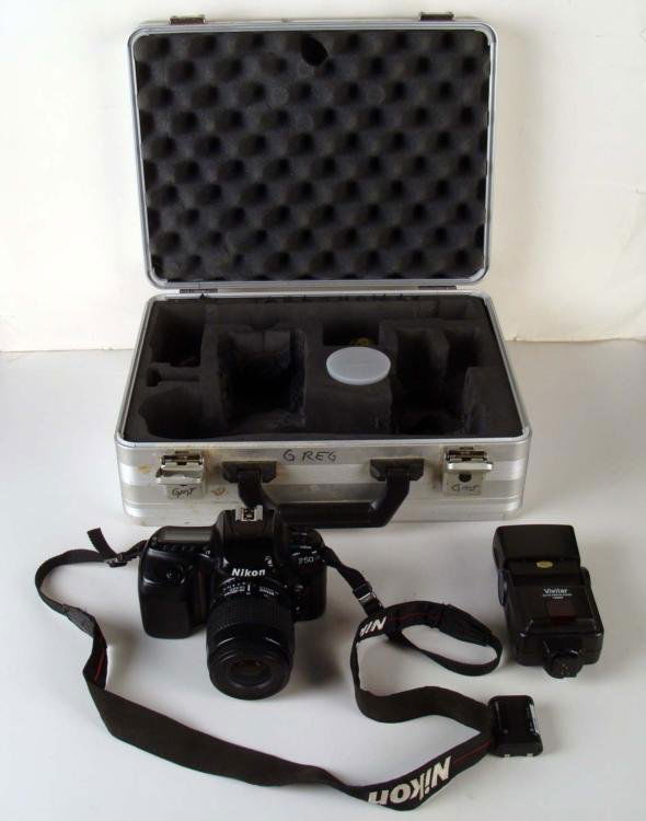 Nikon F50 Set w/ Nikor Lens, Sigma Lens, Flash, Case: This is a Nikon F50 camera with lens, and extras. It is used, and shows some scuffs, but is in good working condition, battery included. * Body: Features Advanced/Simple modes, auto focus and manualLe