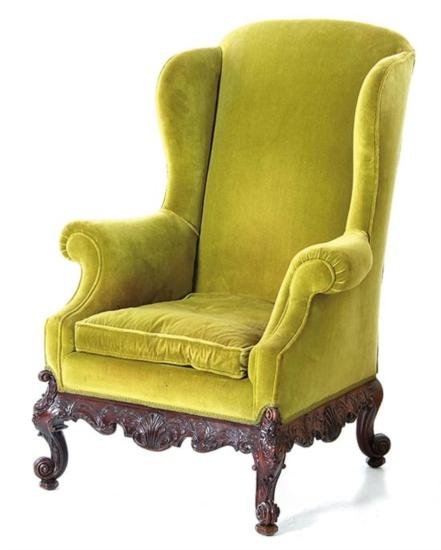 GT0424120062 Chippendale style carved mahogany upholste: Chippendale style carved mahogany upholstered wingback armchair last half 19th century, curved crest emitting shaped wings to outscrolled arms flanking cushion and overupholstered seatrail upon ro