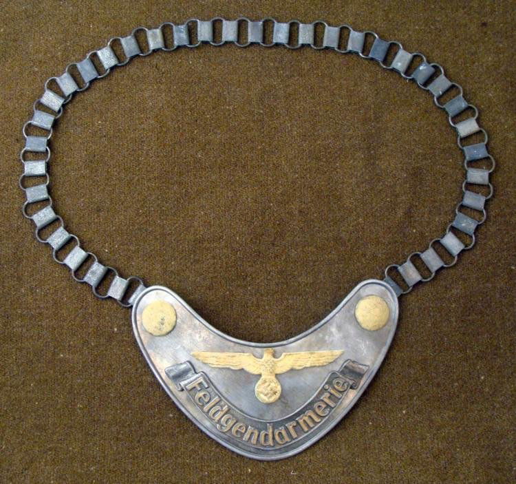 Feldgendarmerie Infantry Chest Gorget RZM M/34/2: Feldgendarmerie Infantry Chest Gorget, with luminescent paint on the eagle and swastika, and end rivets. Has a felt back, and link chain. 6 1/2" wide. RZM M/34/2
