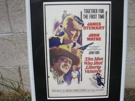 The Man Who Shot Liberty Valance John Wayne: Vintage Poster of John Wayne and Jimmy Stewart in the classic movie " The MAn Who Shot Liberty Valance" Co-stars: Lee Marvin, Vera Miles, Edmund O'Brien, directed by John Ford.Reproduction