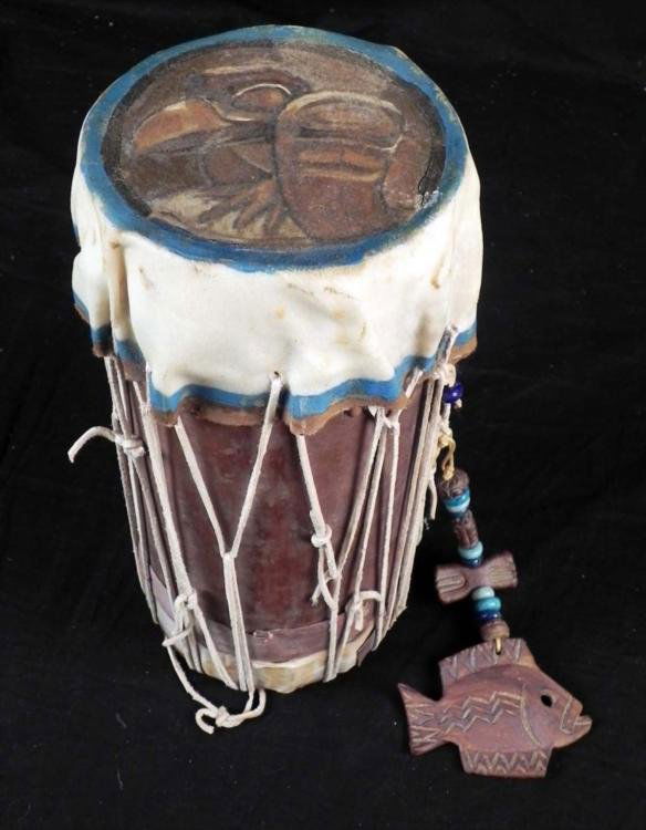 Haitian Authentic Standing Tribal Drum Hand Painted: Here is a Haitian tribal drum, painted on top with a great looking bird. The drum has an animal hide skin and rawhide ropes, with clay fish and beads hanging down. The dimensions are 12" high by 5 1/2