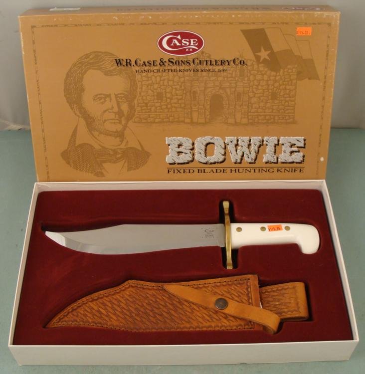 Case XX Bowie Hunting & Survival Knife MIB in Box: This is a classic Case XX Bowie knife with 9" blade, and leather sheath. It is in mint condition in the original box. It features a white handle, and nice woven pattern on the sheath. The box has mini