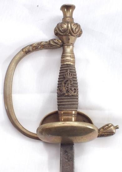ET0523120004 OFFICERS SWORD BASED ON THE PRUSSIAN PATTE: OFFICERS SWORD BASED ON THE PRUSSIAN PATTERN, Germanic, pre 1871 confederation. The brass hilt (remnants of gold) with folding guard and wire wrapped grip with crowned CA cipher. 31in blade (p