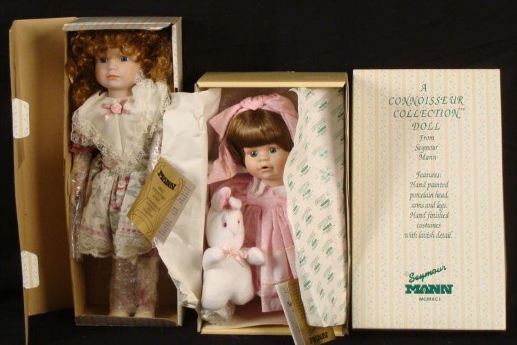 2 Seymour Mann Connoisseur Porcelain Dolls MIB: Here are two blonde haired porcelain dolls from Seymour Mann's Connoisseur Collection. Each is in Mint condition in the original box, with tag and Certificate of Authenticity. One doll has brown hair,