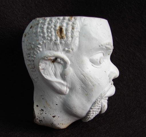 Early Clay Pipe depicting the head of Southern Slave: Early Clay Pipe depicting the head of Southern Slave during the 1840 to 1860 period. This pipe was unearthed at a tavern site in South Carolina and were most probably cast in the south and given to bi