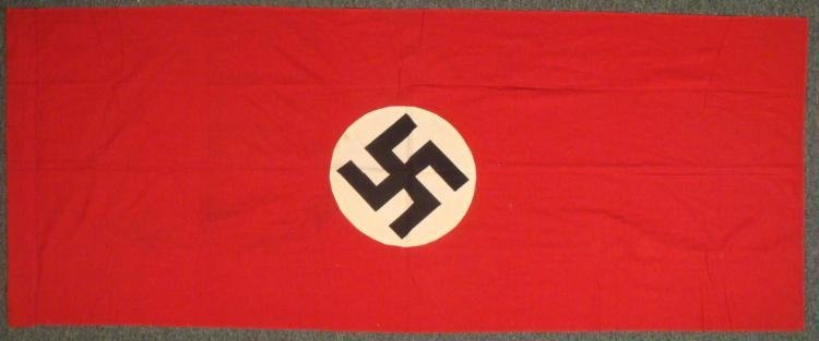 WWII Nazi Germany Flag with Swastika: This is a WWII era Nazi Germany flag with swastika. It is multi-piece construction, with sewn disc on either side. It measures 29 x 74 inches. Its condition is very good to excellent, with no holes an