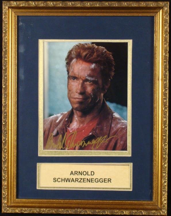 Arnold Schwarzenegger Signed Photo Framed: Here is a photo signed by the Governator, Arnold Schwarzenegger. The autograph appears in gold paint pen. Underneath is his name printed on paper. The photo is an 8 x 10, double matted in black and go