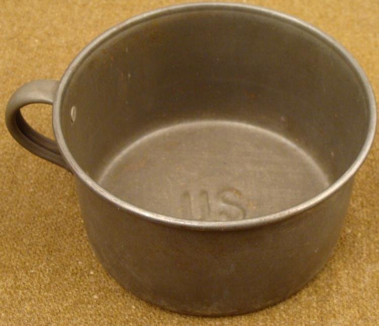LARGE ORIGINGAL SPANISH-AMERICAN WAR COFFEE CUP: THIS IS A LARGE, ORIGINAL SPANISH-AMERICAN WAR COFFEE CUP, FIELD USE. IT IS MADE OUT OF HEAVY OLD METAL. THERE IS A RAISED "US" ON BOTTOM. ITS DIAMETER IS 5". * * *