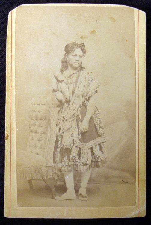 Antique CDV Photo African American in Fancy Dress: This antique carte de visite photo is a portrait of a African American lady wearing a fancy dress. It is a studio shot, mounted on a card, with no studio name listed. The condition is very good overal