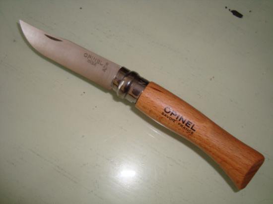 French Opinel pocket knife # 7: Opinel knife #7: 4" closed and 7.25" opened. Beechwood handle and tempered high carbon steel blade with crowned hand hallmark etching. All feature safety ring for locking the blade open or closed.This