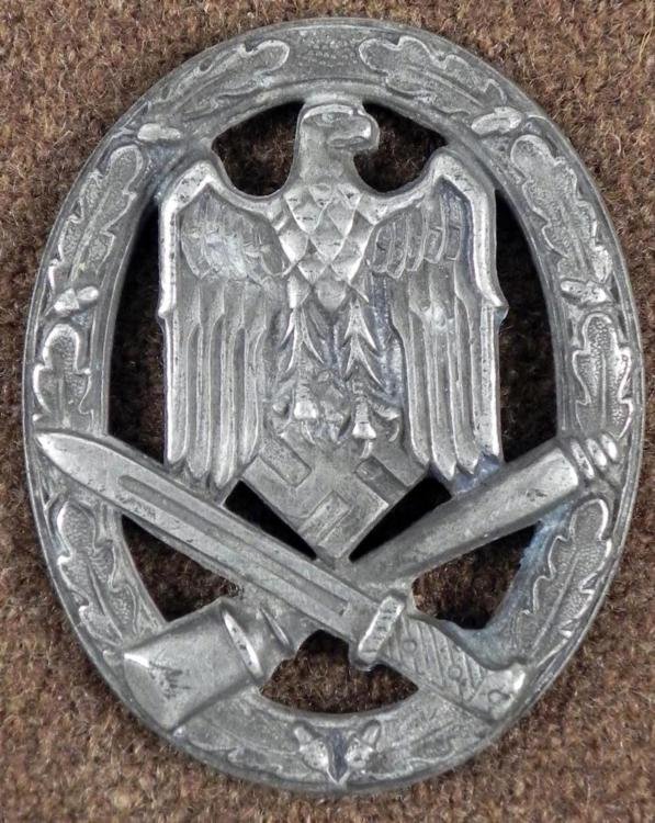 ORIGINAL NAZI GENERAL ASSAULT WEHRMACHT AWARD BADGE: HERE IS AN EARLY ORIGINAL NAZI GENERAL ASSAULT WEHRMACHT AWARD BADGE. ON THE FRONT THERE IS AN EAGLE WITH CROSSED GRENADE & BAYONET. THE REVERSE IS LACKING A PIN & CLASP AND HAS THE MAKER'
