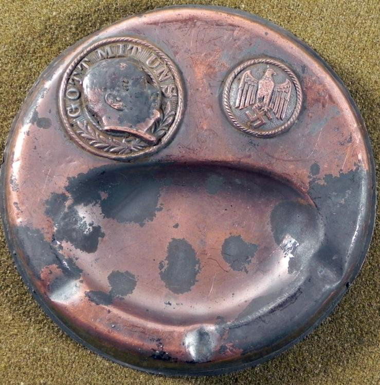 Nazi Soldier Trench Art Ashtray w/Hitler, Swastika: This is a trench art piece made by a a Nazi Soldier as a keepsake. It was made from a 5 1/2 inch diameter copper tone ashtray, with Hitler eagle and swastika. Its condition is good with some surface w