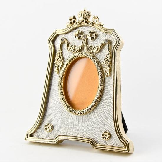 Silver Enameled Faberge Frame: Silver Enameled Faberge Frame, This silver guilloche enamed photo frame contains golden garlands suspended from elegant crystals, the top of which is a ribbon cresting. Dimensions: 4.5in (H) x
