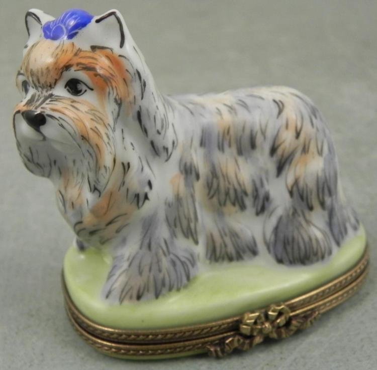 Limoges Dog w/ Blue Bow Box Chamart France: Here is a dog on this Limoges hinged box with a blue decorative piece on its head, and a blue bow inside. * Maker: Limoges, Chamart, France * Dimensions: 2 1/2 inches tall * Condition: Excellent