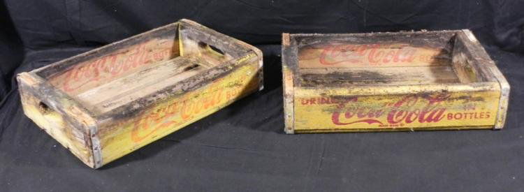 2 Vintage Coca-Cola Coke Bottle Wooden Yellow Crates: These are two vintage wooden crates that once carried Coke in bottles. The sides are painted yellow, with the classic red Coca-Cola logos. The corners are reinforced with metal bands. The dimensions o