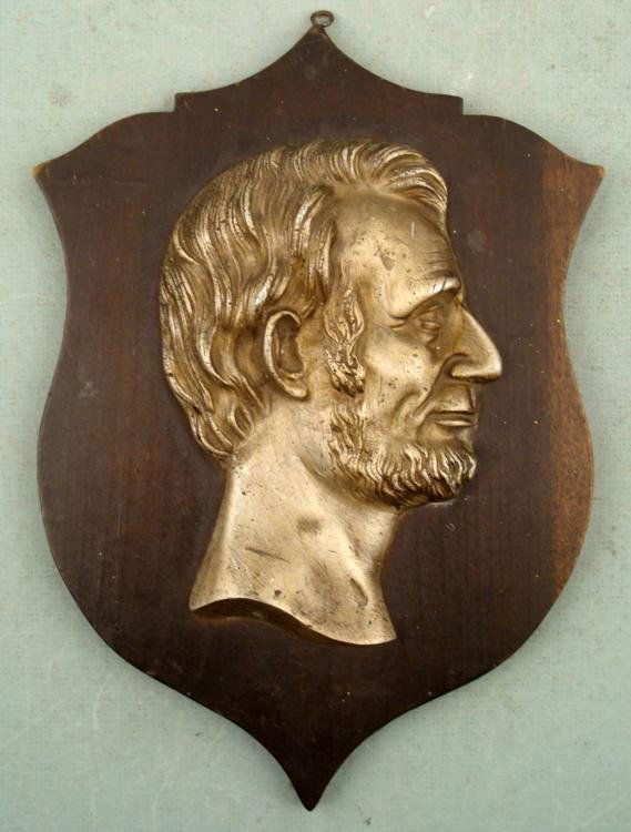 Vintage Abraham Lincoln Presidential Wall Plaque: Here is Abraham Lincoln's head in raised profile on a terrific wall plaque. It the head is fairly heavy silver tone metal with nice details. The plaque is wood and it looks like it was custom made, wi