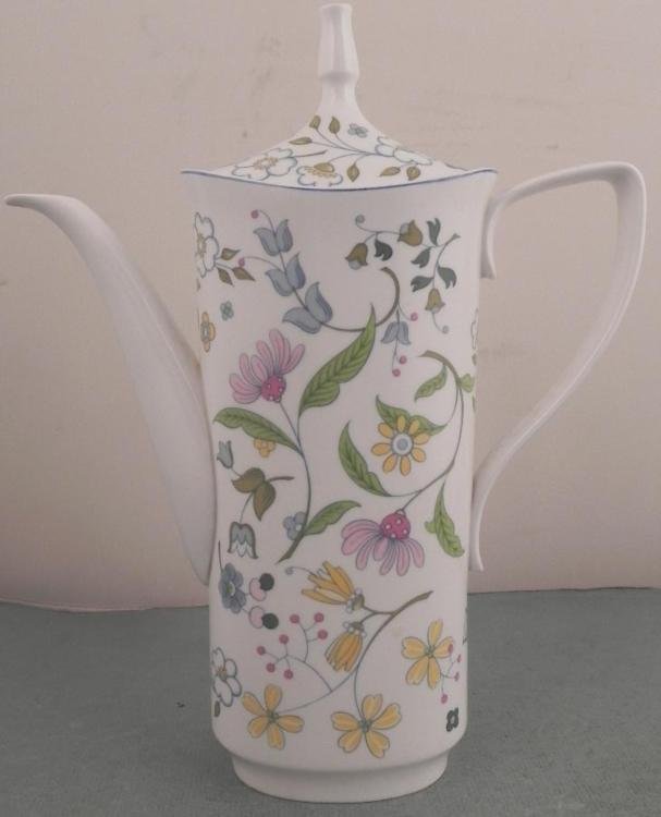 Spode England Bone China Afton Y8212 Tall Pitcher: This is a Tall Pitcher made in England of fine bone China. It is Afton, from a Spode Design, pattern Y8212. It has a pattern of soft colorful flowers, as if they've been swept up in a breeze. It is 