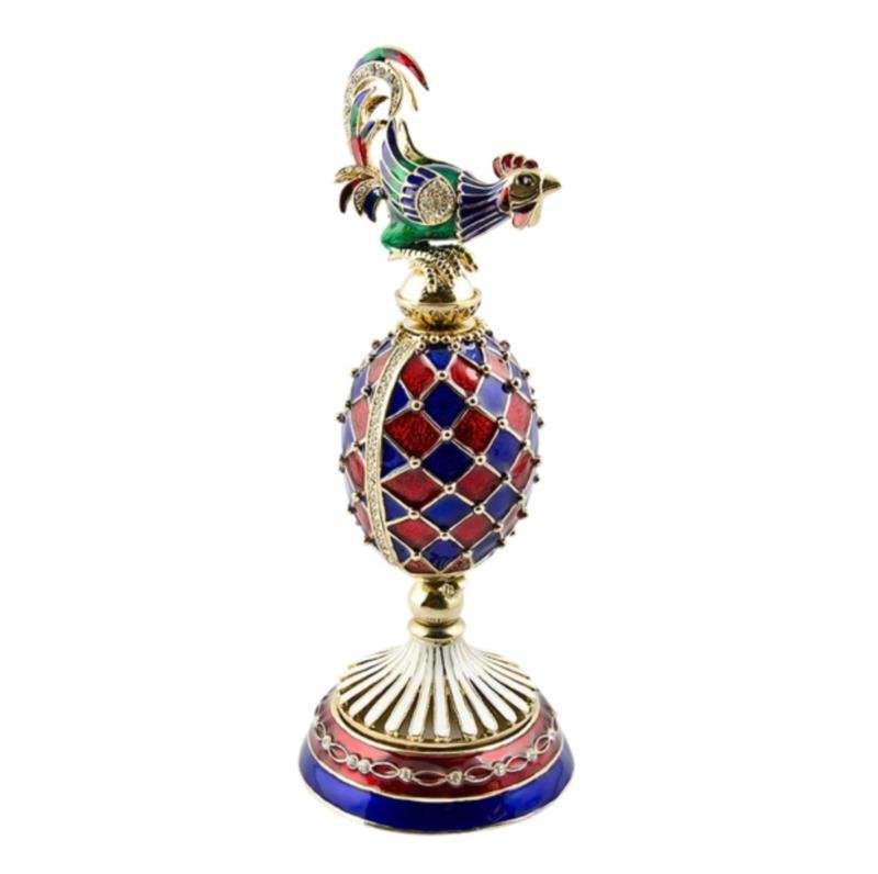 Faberge Rooster Egg: The Faberge Inspired Rooster egg is painted in deep blue and red color and ornamented with golden decor. Crystals are placed along the golden rays. The egg opens vertically to reveal a removable golde