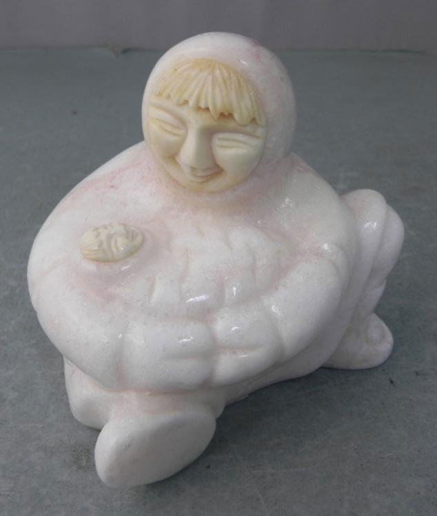 Inuit Alabaster Alaskan Carved Figurine Woman & Child: This is a figurine of a native Inuit Alaskan woman with child all swadled in clothing. The hand carved alabaster stone is beautiful white with tan streaks. It is from Denali, and the original price st