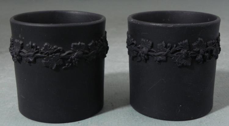2 Black Wedgewood Jasperware Cigarette Holders 1953: This is a pair of vintage Black Wedgewood Jasperware Cigarette Holders, with bands of fruit bearing vines around near the tops. Each is 3 1/4" tall and wide. The bottoms have the maker name, Made in E