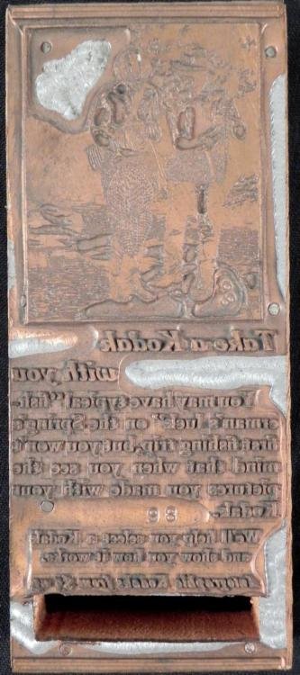 Kodak Camera Old Ad Large Copper Printers Block 1920s: This copper printers block was made for a print ad for Kodak cameras. The scene shows a stream, with a lady holding a Kodak and a man holding a fishing rod. The text is about a fishing trip. The block