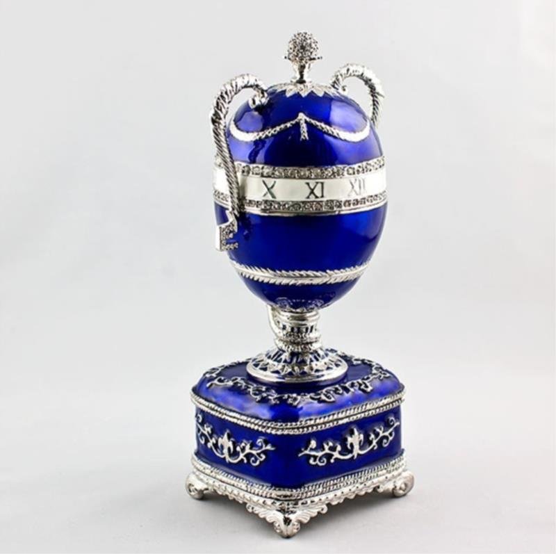 Blue Serpent Clock Faberge Inspired Egg: The Blue Serpent Clock Egg was presented to Tsarina Maria Feodorovna by Alexander III on Easter day, April 5th, 1887. It is possible that by this time, the egg gift was already an establis