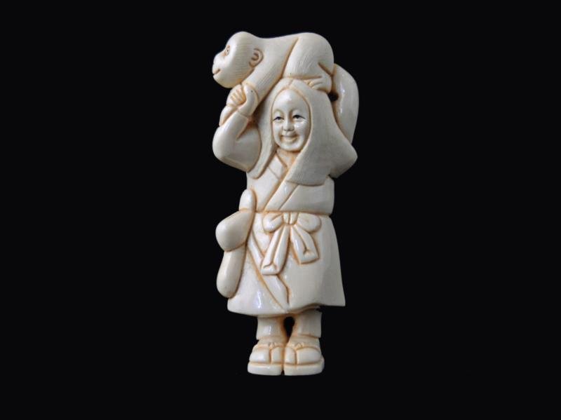Hand Carved Ivory Netsuke Figure: Hand Carved Ivory Netsuke Figure measures 3 inches tall