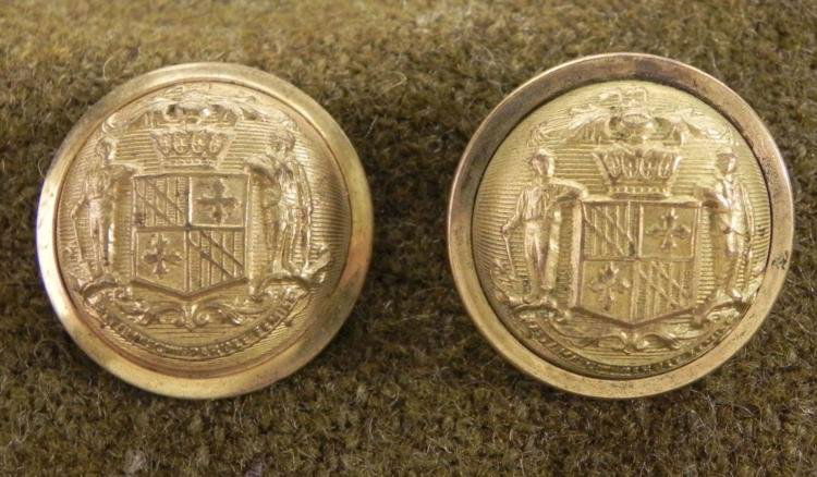 2 Maryland State Seal Gilt Buttons Civil War: 2 Maryland State Seal buttons, in gilt, dating from early post Civil War * Obverse: 2 figures, and motto: Montani Semper Liberi * Reverse: WATERBURY BUTTON CO.; JACOB GMINDERDiameter: 22 mmCondition: