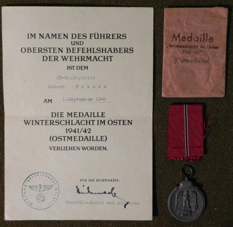 ORIGINAL RUSSIAN FRONT MEDAL RIBBON-DOCUMENT ENVELOPE: HERE ARE GROUPING OF ORIGINAL RUSSIAN FRONT MEDAL-RIBBON-DOCUMENT & ENVELOPE TO THE SAME MAN. THIS IS AN OUTSTANDING, GUARANTEED ORIGINAL GROUPING TO NAZI ROBERT PETERS. HIS RUSSIAN FRONT MEDA