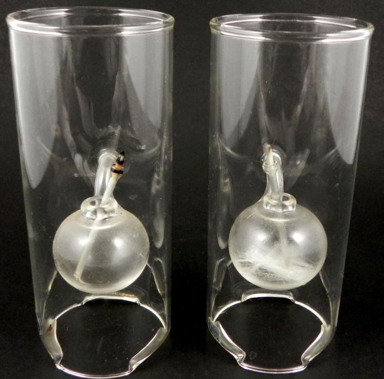 Pair of Wolfard Hand Blown Glass Oil Lanterns Lamps: This is a pair of clear hand blown glass oil lamps from Wolfard Glass. They feature spherical chambers that can be filled from the sides, and removable wicks. They are 9 x 4 inches. They have not been