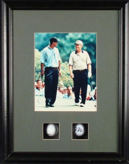 Tiger Woods Jack Nicklaus Signed Golf Balls, Photo Frmd: This framed piece displays an 8 x 10 photo of two of golf's masters, Tiger Woods, and Jack Nicklaus and just below are a pair of signed balls. The Woods has signed in blue Sharpie, and Nicklaus in bla