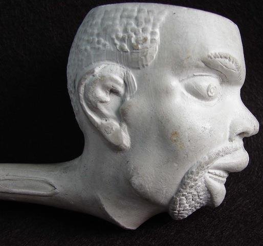 Early Clay Pipe depicting the head Southern Slave: Early Clay Pipe depicting the head of Southern Slave during the 1840 to 1860 period. This pipe was unearthed at a tavern site in South Carolina and were most probably cast in the south and given to bi