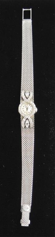 Patek Philippe Ladies Platinum and Diamond Watch: Patek Philippe Ladies Platinum and Diamond Watch. Band accented with 2 marquise-cut diamonds, total estimated weight .40 cts. and 34 round and full-cut diamonds, total estimated weight .54 cts