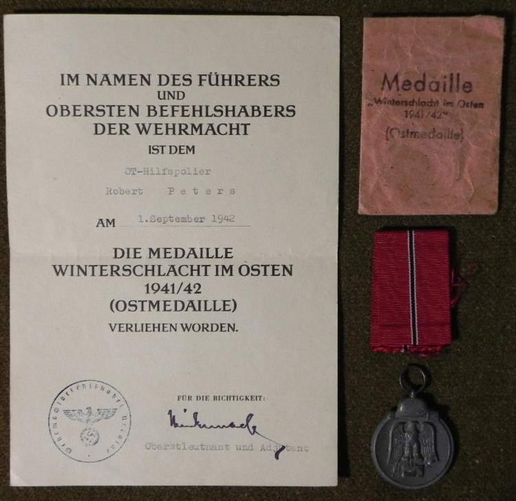 ORIGINAL RUSSIAN FRONT MEDAL RIBBON-DOCUMENT ENVELOPE: HERE ARE GROUPING OF ORIGINAL RUSSIAN FRONT MEDAL-RIBBON-DOCUMENT & ENVELOPE TO THE SAME MAN. THIS IS AN OUTSTANDING, GUARANTEED ORIGINAL GROUPING TO NAZI ROBERT PETERS. HIS RUSSIAN FRONT MEDA