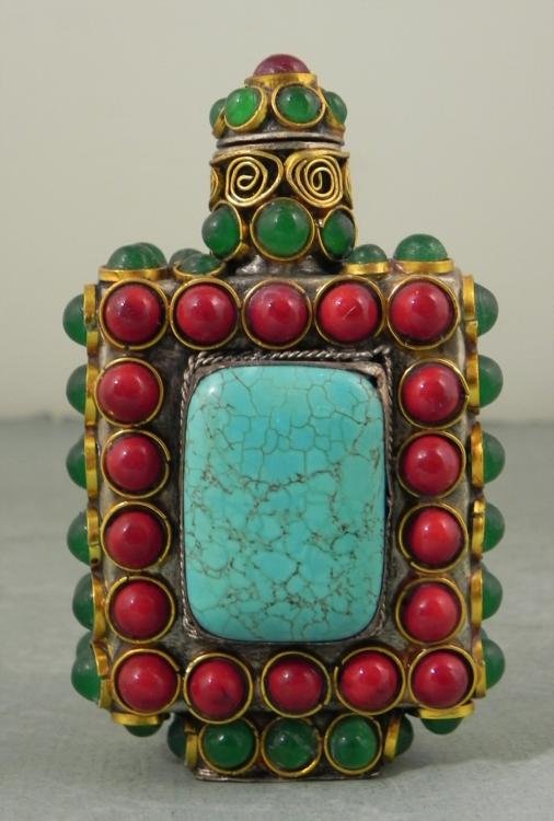 Vintage Asian Snuff/Perfume Bottle w/Turquoise: This is an antique snuff or perfume bottle, fully adorned with red and green stones, filigreed gold metal, and nice turquoise on either side. The cap has a long wand. Its dimensions with the cap on ar